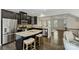 Stylish kitchen with dark cabinets, granite countertops, stainless steel appliances, and breakfast bar seating at 1317 Queen Lyon Ct, Charlotte, NC 28205