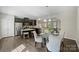 Stylish kitchen with dark cabinets, granite countertops, stainless steel appliances, and breakfast bar seating at 1317 Queen Lyon Ct, Charlotte, NC 28205
