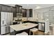 Stylish kitchen with dark cabinets, granite countertops, stainless steel appliances, and breakfast bar seating at 1317 Queen Lyon Ct, Charlotte, NC 28205