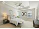 The main bedroom features a ceiling fan, tray ceiling, bedside tables, and three windows at 1317 Queen Lyon Ct, Charlotte, NC 28205