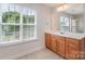 Bathroom featuring a vanity with wood cabinets and a bright window for natural lighting at 1615 Jekyll Ln, Waxhaw, NC 28173