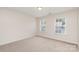 Bedroom featuring neutral walls, carpet, and two windows for natural lighting at 1615 Jekyll Ln, Waxhaw, NC 28173