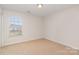 Bedroom featuring neutral walls, carpet, and a bright window for natural lighting at 1615 Jekyll Ln, Waxhaw, NC 28173
