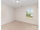 Bedroom with neutral walls, carpet, and a window for natural lighting at 1615 Jekyll Ln, Waxhaw, NC 28173