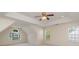 Large bedroom featuring neutral carpet, multiple windows, and tray ceiling at 1615 Jekyll Ln, Waxhaw, NC 28173