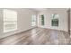 Bright bedroom featuring modern floors and three large windows at 1615 Jekyll Ln, Waxhaw, NC 28173