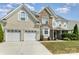 Charming two-story home featuring a two-car garage, brick accents, and a well-maintained lawn at 1615 Jekyll Ln, Waxhaw, NC 28173