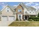 Charming two-story home featuring a two-car garage, brick accents, and a well-maintained lawn at 1615 Jekyll Ln, Waxhaw, NC 28173