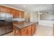 Open-concept kitchen with island and stainless steel refrigerator at 1615 Jekyll Ln, Waxhaw, NC 28173