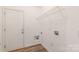 Bright laundry room includes a door to the outside and a wire rack shelf at 1615 Jekyll Ln, Waxhaw, NC 28173