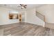 Open-concept living room with modern floors, staircase, and adjacent kitchen at 1615 Jekyll Ln, Waxhaw, NC 28173