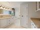 Bright bathroom featuring double vanity, soaking tub, and wood accents at 19528 Mary Ardrey Cir, Cornelius, NC 28031