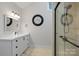 Bathroom featuring white cabinetry, stone floors, modern lighting, and a glass enclosed shower at 19528 Mary Ardrey Cir, Cornelius, NC 28031