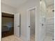 Neutral-toned bathroom with glass shower, tile floor, and doorway to bedroom at 19528 Mary Ardrey Cir, Cornelius, NC 28031