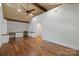 Bright bedroom boasts hardwood floors, wood-paneled ceiling, and built-in desk and shelving at 19528 Mary Ardrey Cir, Cornelius, NC 28031