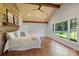 Light-filled bedroom with vaulted wood ceiling, large windows overlooking landscaped yard at 19528 Mary Ardrey Cir, Cornelius, NC 28031
