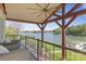 Outdoor deck overlooking the lake with comfortable seating and wood beams at 19528 Mary Ardrey Cir, Cornelius, NC 28031