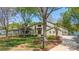 Stunning two-story home boasts a beautiful lawn, mature trees, and a charming front entrance on a sunny day at 19528 Mary Ardrey Cir, Cornelius, NC 28031