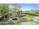 Waterfront backyard with manicured lawn, stone retaining wall, outdoor living spaces, and private dock at 19528 Mary Ardrey Cir, Cornelius, NC 28031