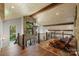 Beautiful loft area with wooden ceiling beams, hardwood floors, and ornate chandelier at 19528 Mary Ardrey Cir, Cornelius, NC 28031