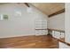 Office featuring custom built-in shelves and cabinets, hardwood floors, and a vaulted ceiling at 19528 Mary Ardrey Cir, Cornelius, NC 28031