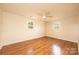 Bedroom featuring vinyl wood floors, ceiling fan, and two windows for natural light at 1993 Moss Farm Rd, Hickory, NC 28602
