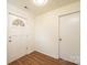 Hallway featuring paneled walls, vinyl floors, and a front door with decorative window at 1993 Moss Farm Rd, Hickory, NC 28602