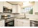 Well-equipped kitchen featuring stainless steel appliances, white cabinets, and ample countertop space at 1993 Moss Farm Rd, Hickory, NC 28602