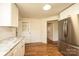 View of a kitchen featuring white cabinets, stainless steel appliances, and hardwood floors at 1993 Moss Farm Rd, Hickory, NC 28602