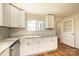 Charming kitchen featuring white cabinets, marble countertops, stainless steel appliances, and wood flooring at 1993 Moss Farm Rd, Hickory, NC 28602