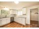 Well-lit kitchen with white cabinets, a large window, and modern appliances and fixtures at 1993 Moss Farm Rd, Hickory, NC 28602
