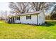 Side view of the home showcasing the well-maintained lawn and exterior at 1993 Moss Farm Rd, Hickory, NC 28602