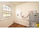 Water heater inside well lit utility room with a window for extra light at 1993 Moss Farm Rd, Hickory, NC 28602