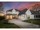 Stunning two-story home with a three-car garage, manicured lawn, and inviting front porch at 20637 Island Forest Dr, Cornelius, NC 28031