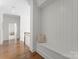 Hallway features a built-in bench, hardwood floors and all-white trim at 20637 Island Forest Dr, Cornelius, NC 28031