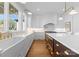 Stylish kitchen with white cabinetry, marble countertops, and high-end stainless steel appliances at 20637 Island Forest Dr, Cornelius, NC 28031