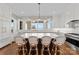 Gourmet kitchen island with marble countertops, bar seating, and elegant pendant lighting at 20637 Island Forest Dr, Cornelius, NC 28031