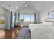 Bright main bedroom with hardwood floors, large windows offering a beautiful view, and vaulted ceilings at 20637 Island Forest Dr, Cornelius, NC 28031