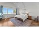 Bright main bedroom with hardwood flooring, a ceiling fan, and water views at 20637 Island Forest Dr, Cornelius, NC 28031