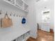 Mudroom featuring built-in bench with storage and shiplap wall with hooks at 20637 Island Forest Dr, Cornelius, NC 28031