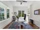 Bright office with natural light, built-in shelving, and a modern ceiling fan at 20637 Island Forest Dr, Cornelius, NC 28031