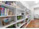 Walk-in pantry with built-in white shelves and hardwood floors for optimal kitchen storage at 20637 Island Forest Dr, Cornelius, NC 28031