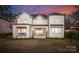 Stunning rear exterior with covered patio, large windows, and a beautifully landscaped yard at 20637 Island Forest Dr, Cornelius, NC 28031