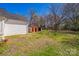 Exterior view of the backyard featuring sheds and grass and trees at 208 Columbia Ave, Rock Hill, SC 29730