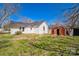Exterior view of the backyard featuring a shed and a home with white siding at 208 Columbia Ave, Rock Hill, SC 29730