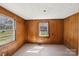 This bedroom includes wood paneling, natural light and hardwood floors at 208 Columbia Ave, Rock Hill, SC 29730