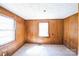 This bedroom includes wood paneling, natural light and hardwood floors at 208 Columbia Ave, Rock Hill, SC 29730
