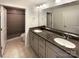 Bathroom with double vanity, granite countertop, framed mirrors and a glass shower at 2085 Saddlebred Dr, Iron Station, NC 28080