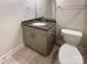 Bathroom featuring a gray vanity with granite countertop, oval sink, and chrome fixtures at 2085 Saddlebred Dr, Iron Station, NC 28080