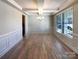 Dining room featuring dark wood floors, wainscoting, coffered ceilings and natural light at 2085 Saddlebred Dr, Iron Station, NC 28080